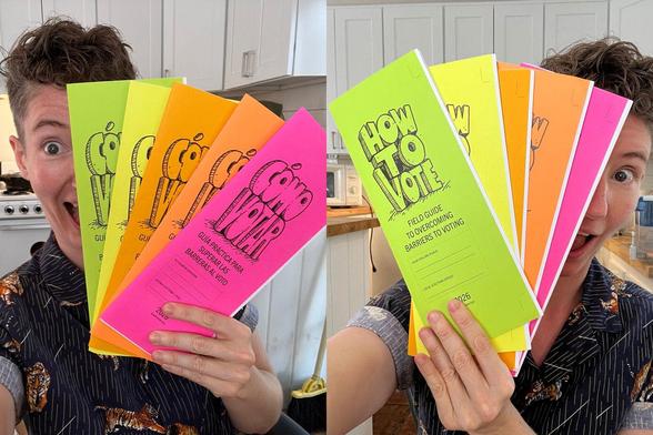 A woman holding up a batch of the how to vote zines. They have text in two languages.