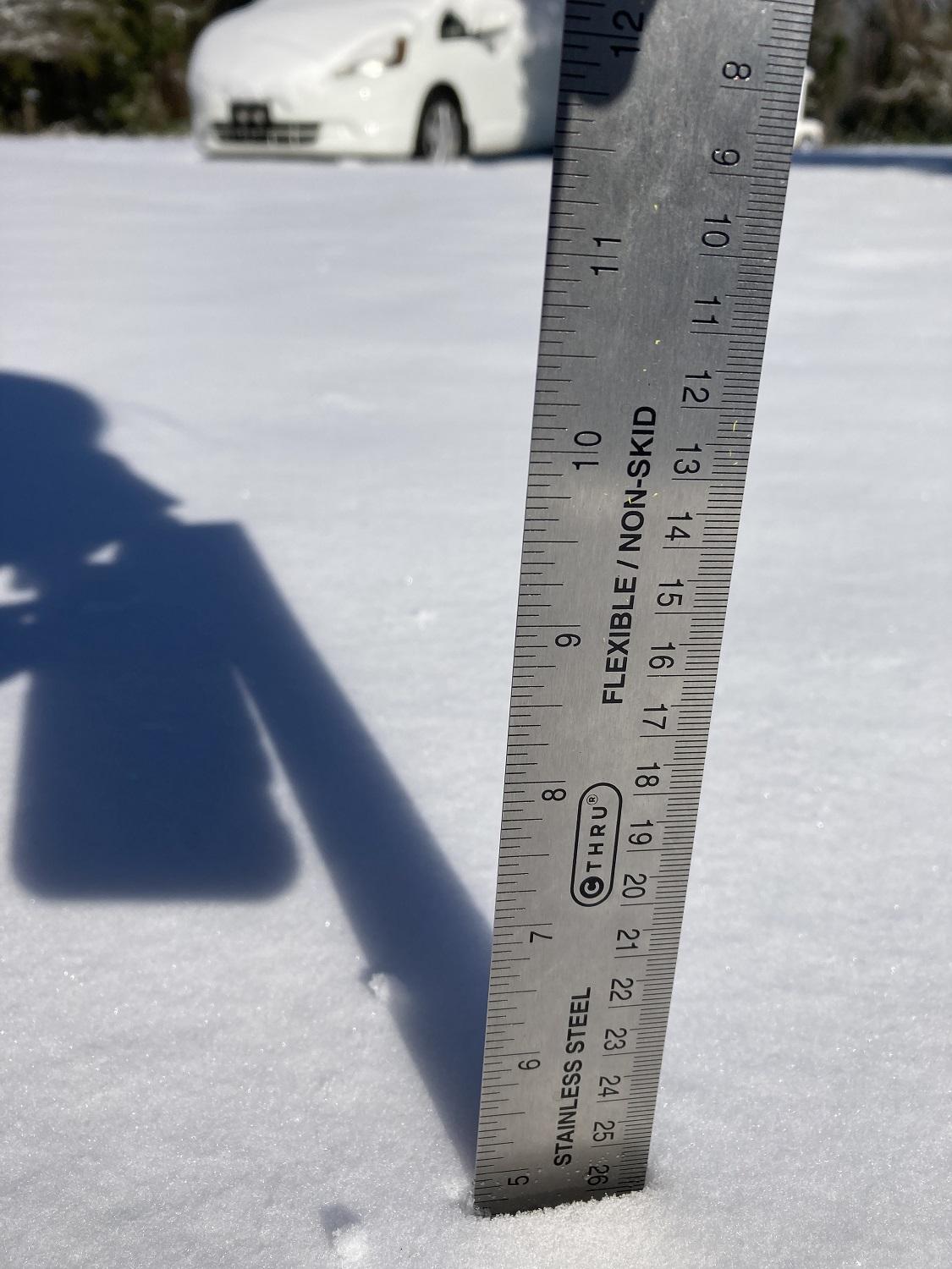 A ruler dipped in snow to measure the amount of snowfall from yesterday and last night.