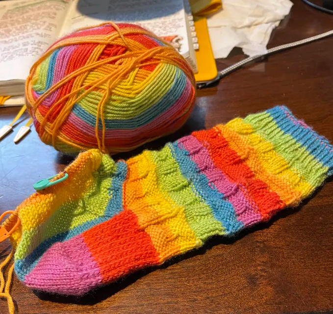 Almost completed rainbow knit socks. Well. One sock.