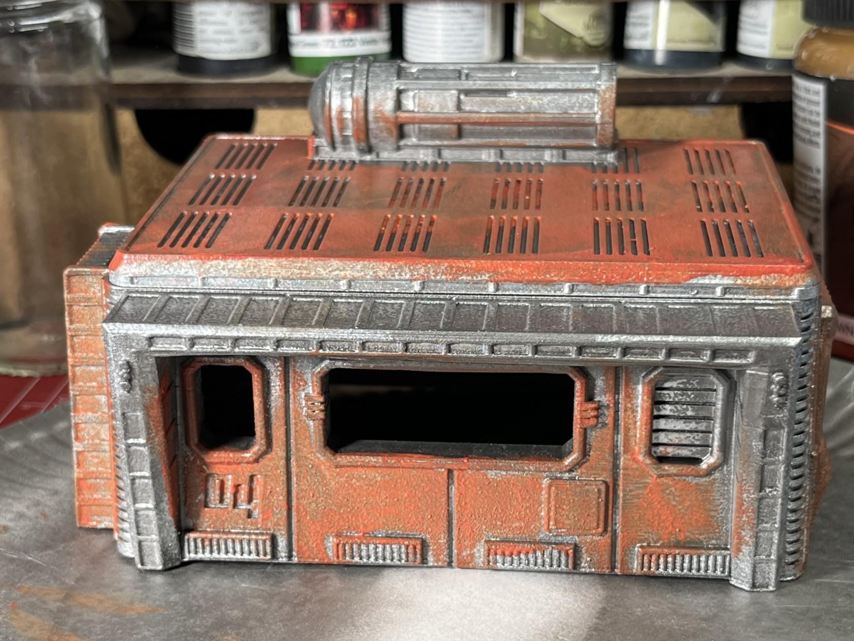 Front view of a badly painted orange sci-fi 28mm scale model building.