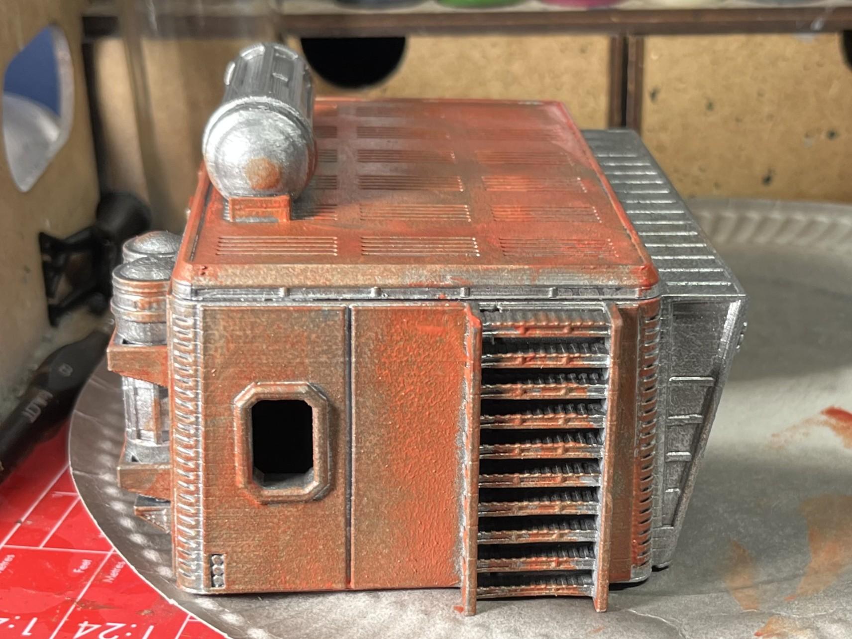 Another side view of a badly painted orange sci-fi 28mm scale model building.