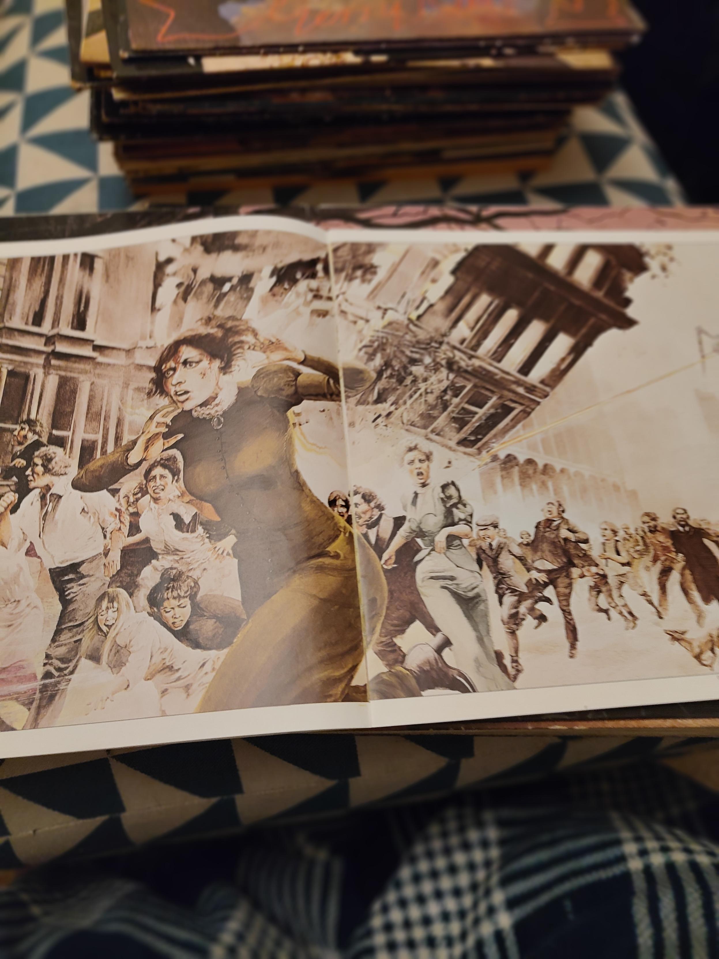 Artwork of people screaming while running down the street while buildings collapse around them from the 1978 War of the Worlds book that came with the vinyl