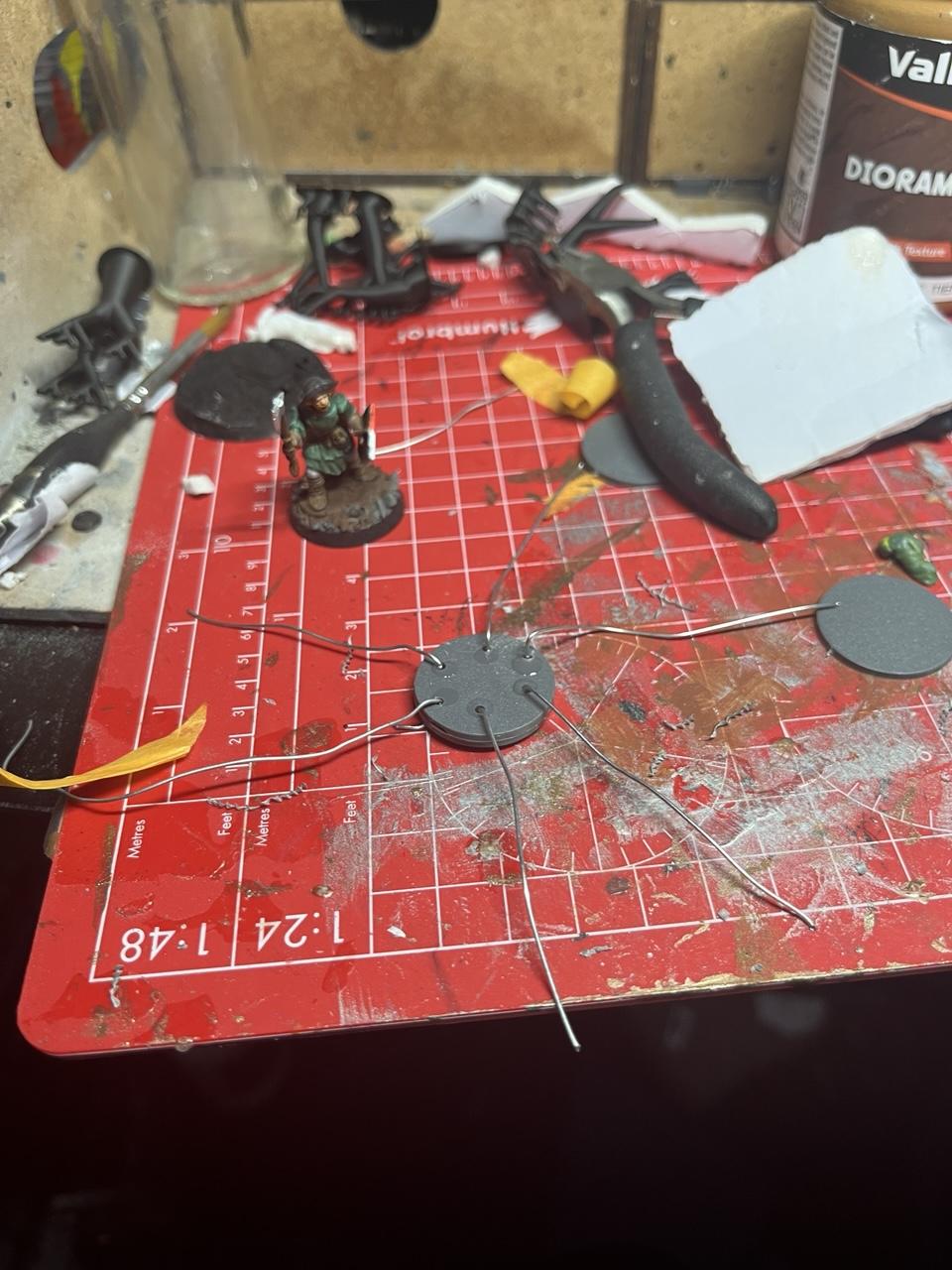 A work in progress wire model thing next to a medieval fantasy 28mm model