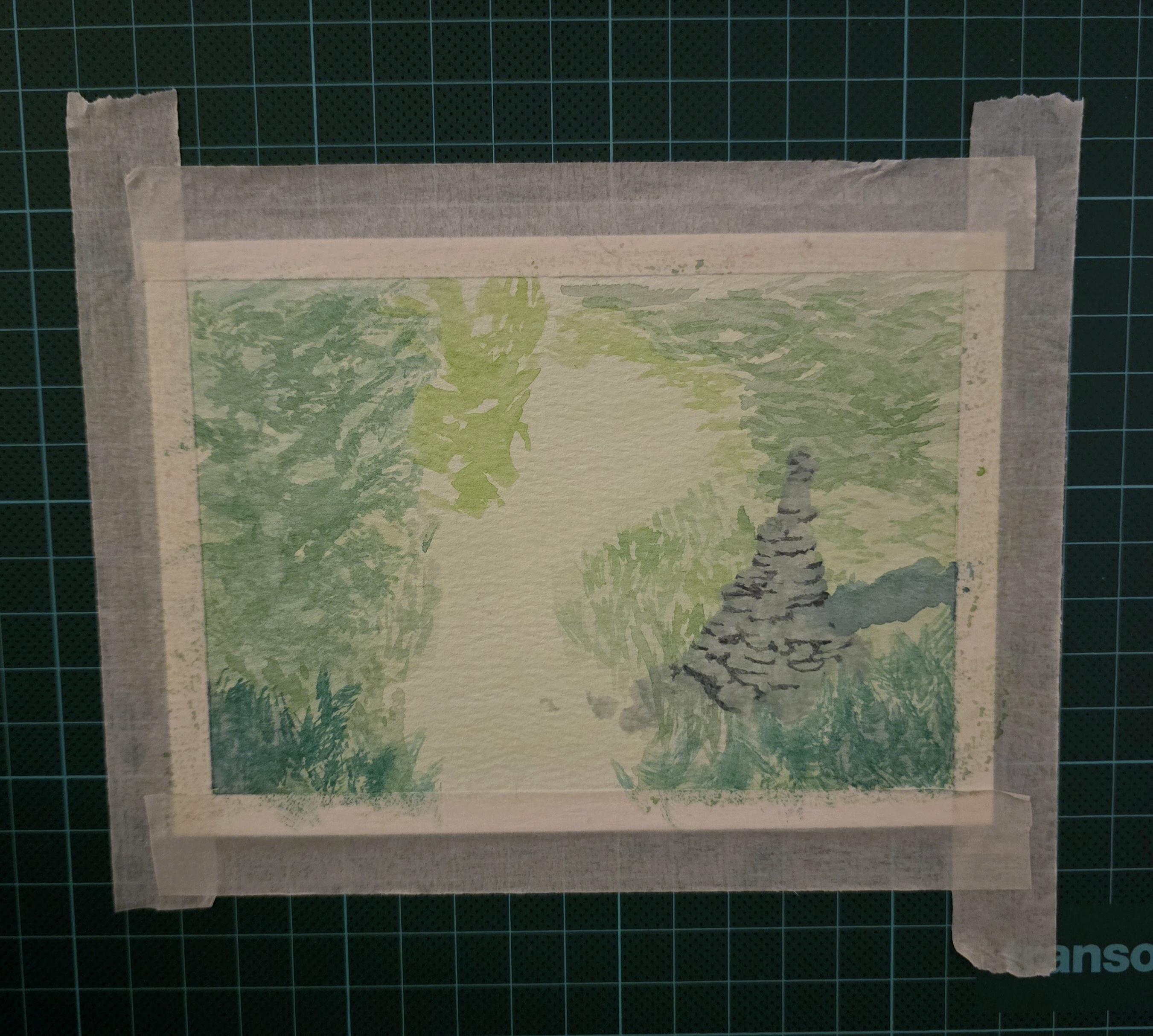 A small watercolor landscape taped to a painting surface. Most of the shapes are shades of green, vaguely foliage shaped. In the front right, though, there is a stack of grey slate or flat stone, shapes cut out with shadow